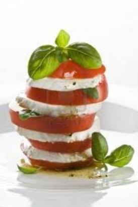 Stacked fresh mozzarella and tomato slices topped with basil